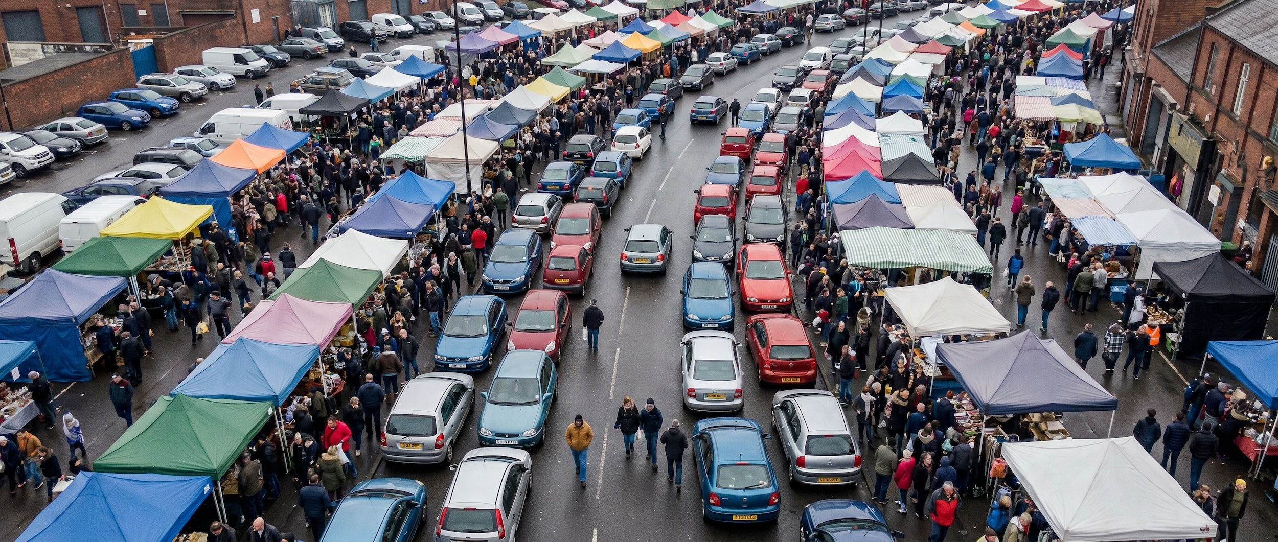 Compact Nissan vehicles easily parking at crowded Birmingham AL street festival