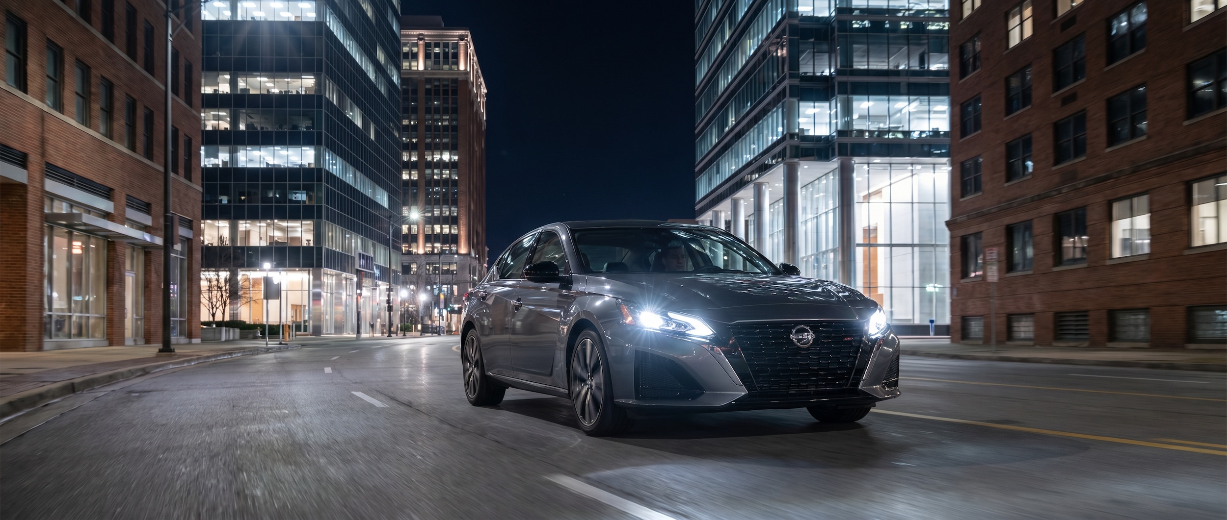 Nissan Altima LED headlights illuminating downtown Birmingham, AL streets at night