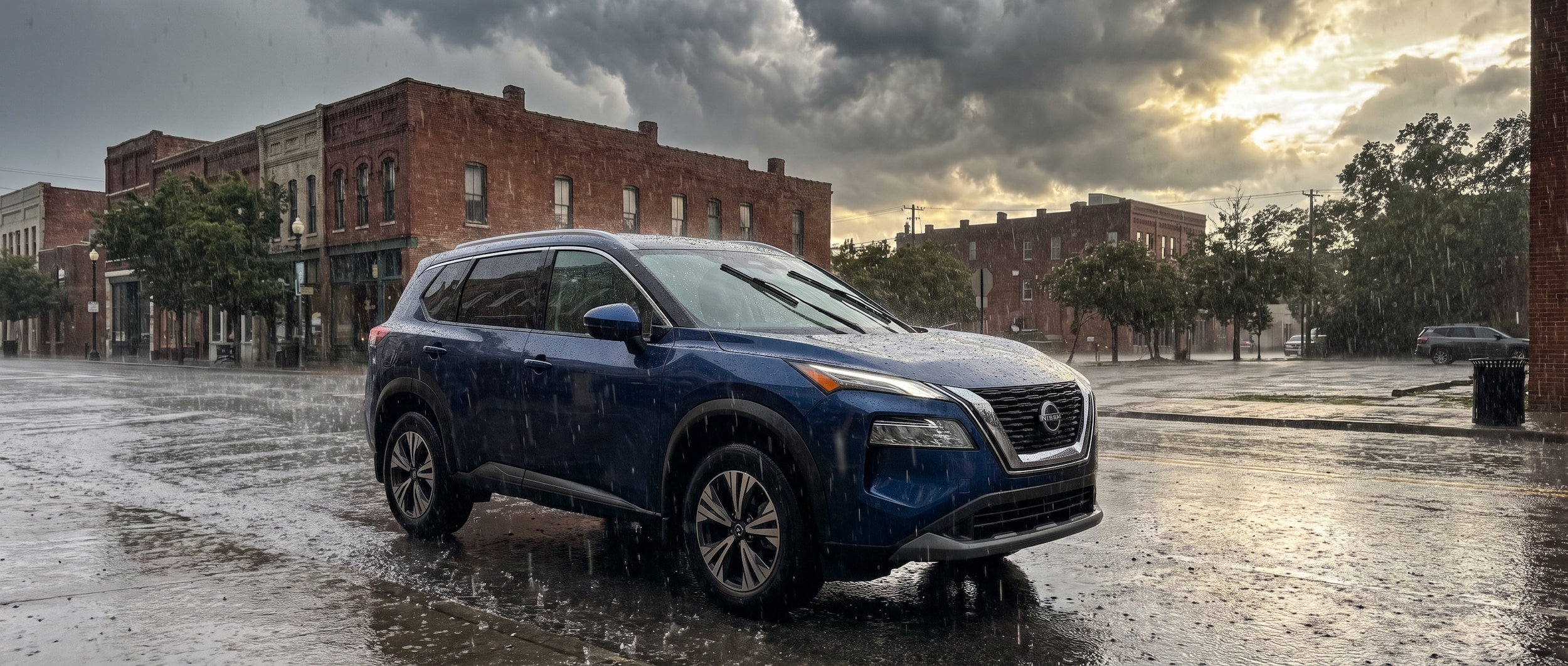 2026 Nissan Rogue with wipers running on a rainy Birmingham street during a summer thunderstorm