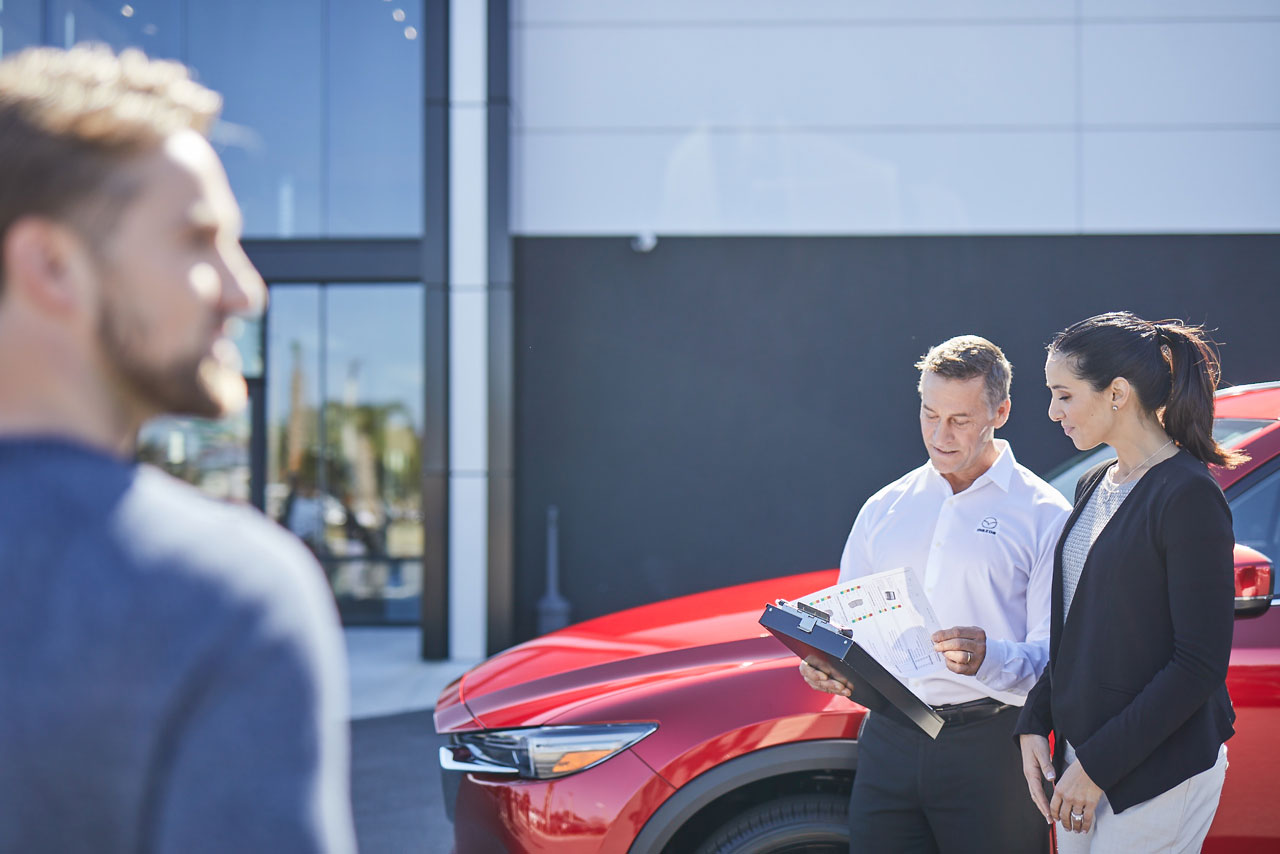 customers at car dealership image