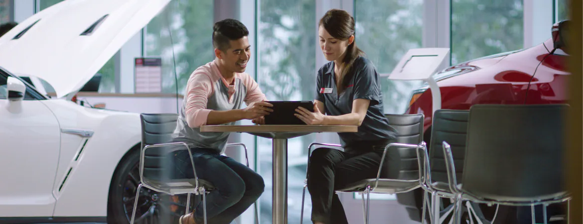 nissan-employee-showing-man-gap-insurance-on-tablet.webp