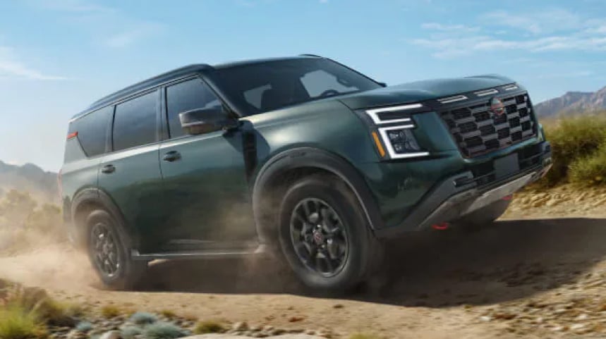 Green Nissan SUV driving offroad