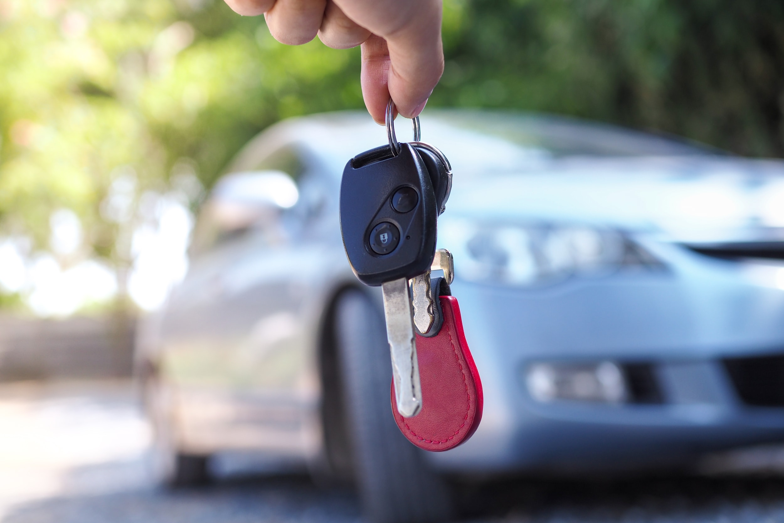 Dangling keys in hand infront of vehicle