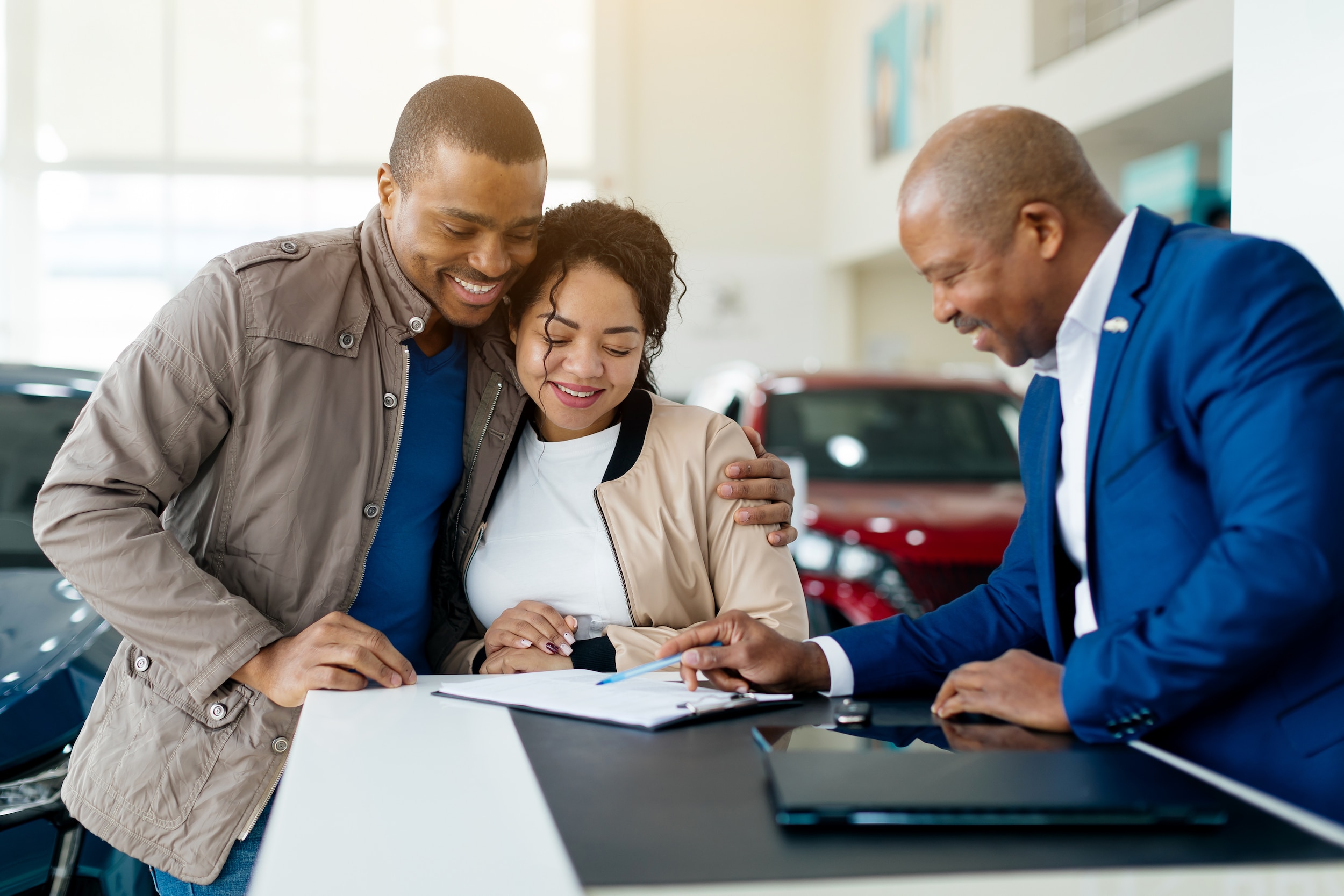 Couple examining documents with sales person