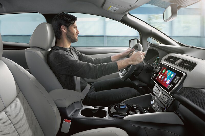Interior shot of a man driving a 2023 Nissan LEAF.png