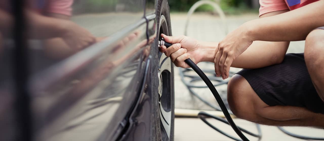 Person checks Tire Pressure