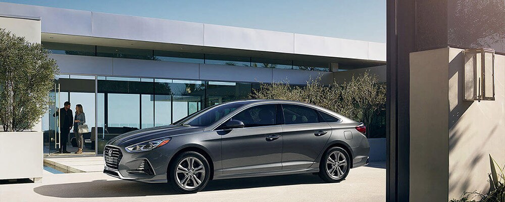 2018 Hyundai Sonata parked in front of home banner