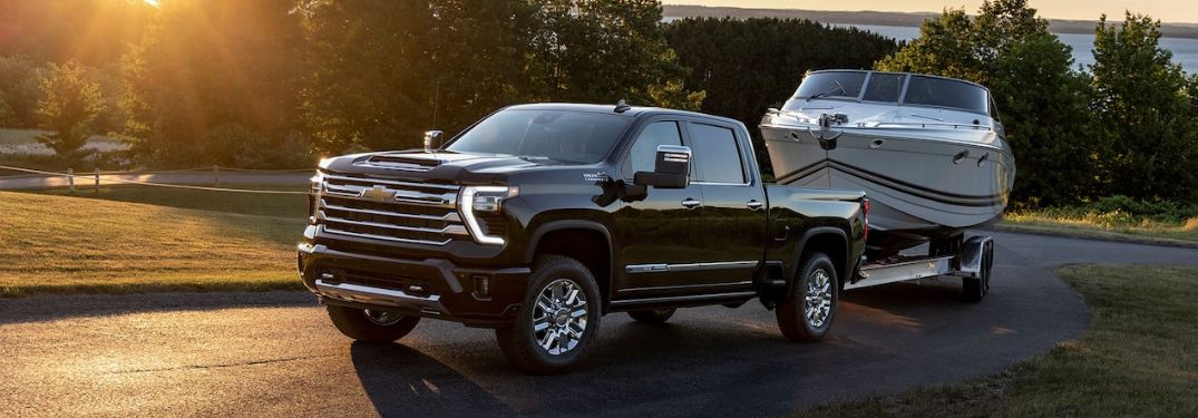 Black 2024 Chevy Silverado HD Towing a Boat