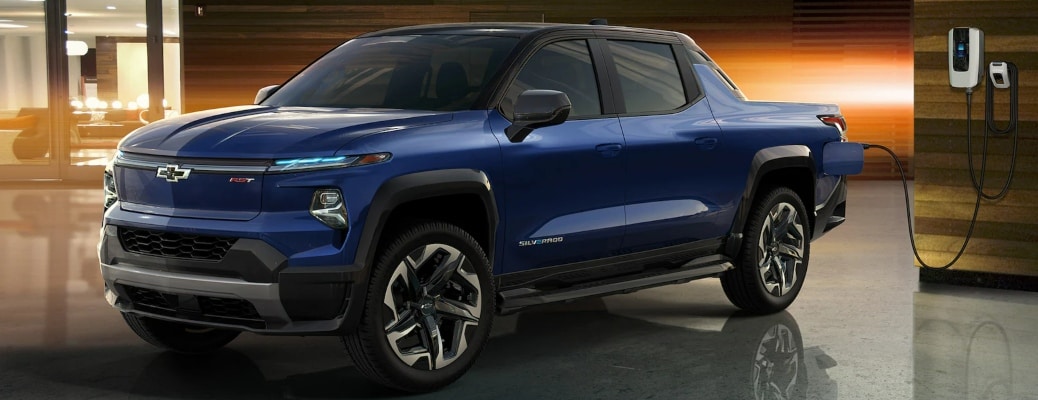 2024 Chevy Silverado EV blue side view while charging