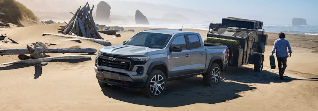 Gray 2023 Chevy Colorado Towing a Trailer on a Beach