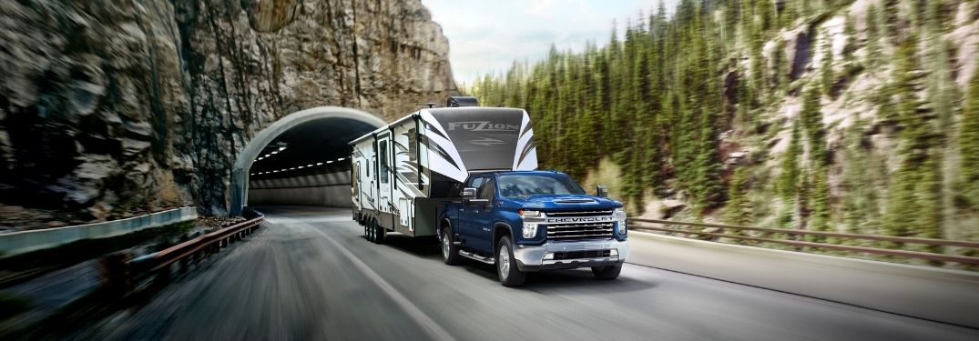 Blue 2022 Chevy Silverado 2500HD Towing a Trailer