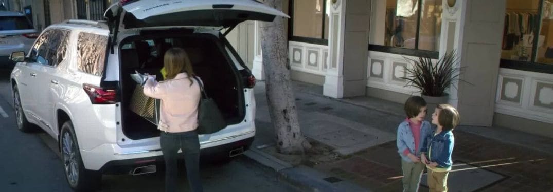 Woman Loading Cargo in the Back of a 2023 Chevy Traverse