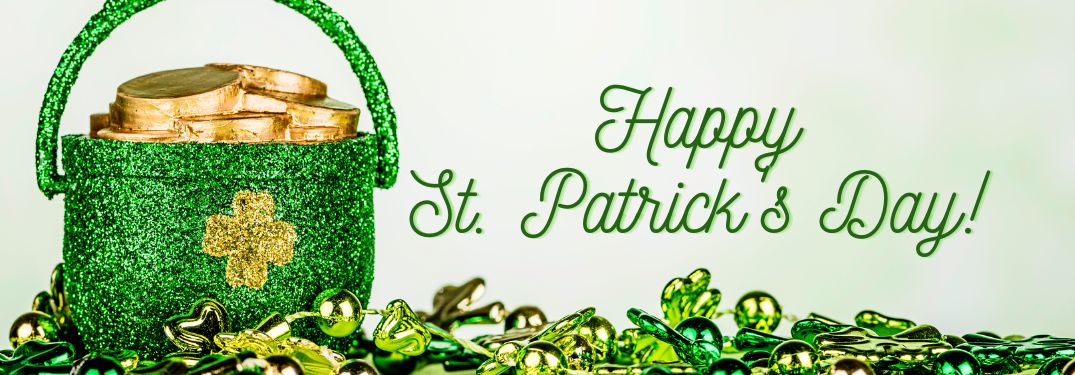 Green Pot of Gold and St. Patrick's Day Decorations on White Background with Green Happy St. Patrick's Day Text