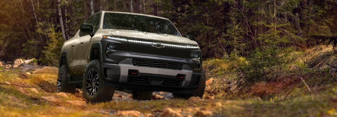 Tan 2024 Chevy Silverado EV Trail Boss Front Exterior on Wooded Trail