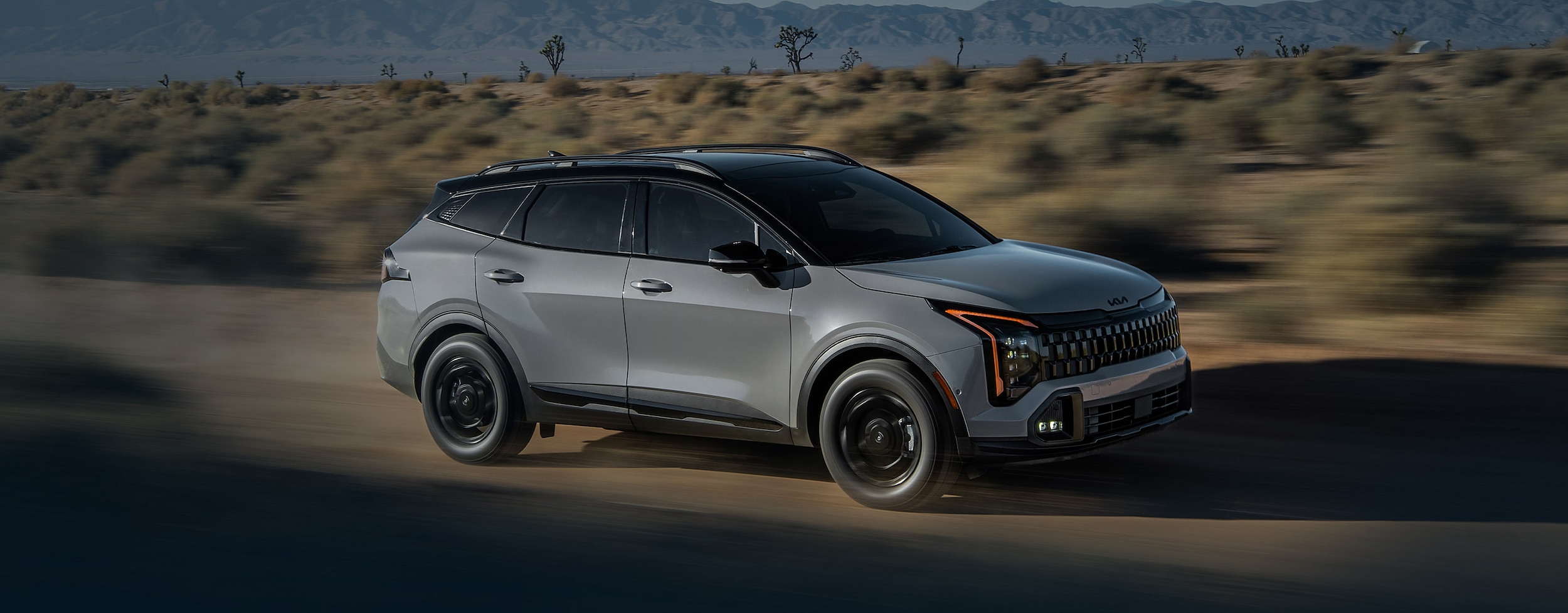 Kia driving on a dirt road