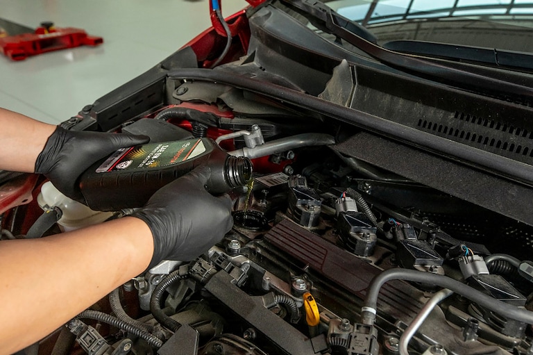Service technician performaing an oil change