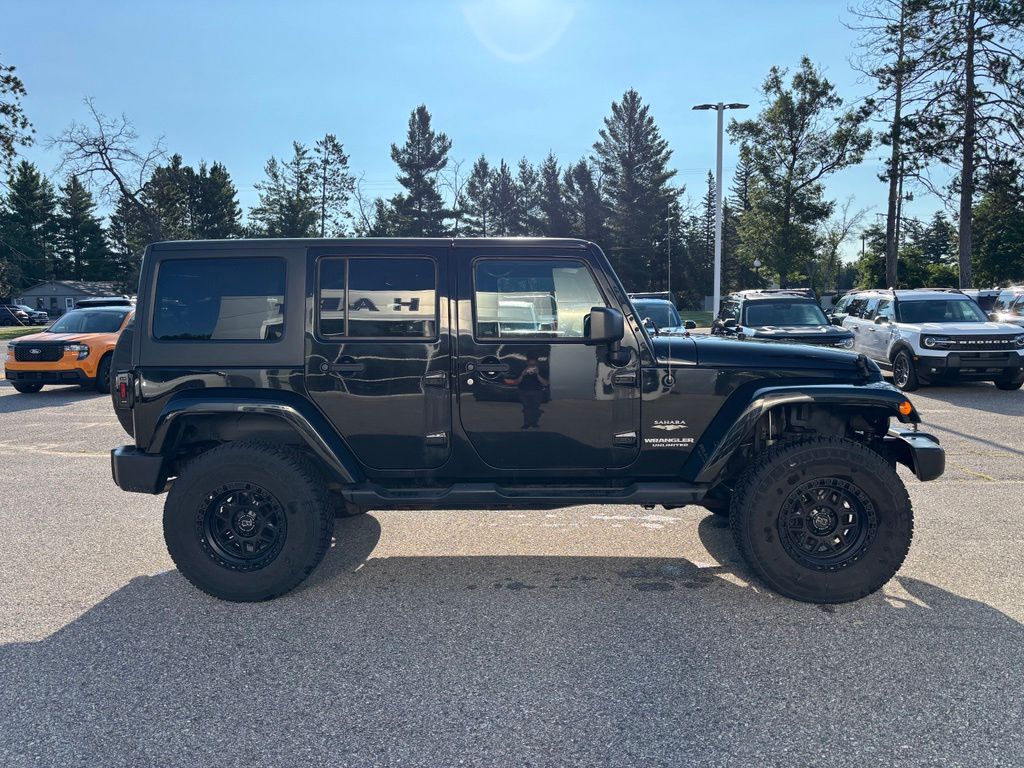Used 2014 Jeep Wrangler Unlimited Sahara with VIN 1C4BJWEG8EL285695 for sale in Roscommon, MI