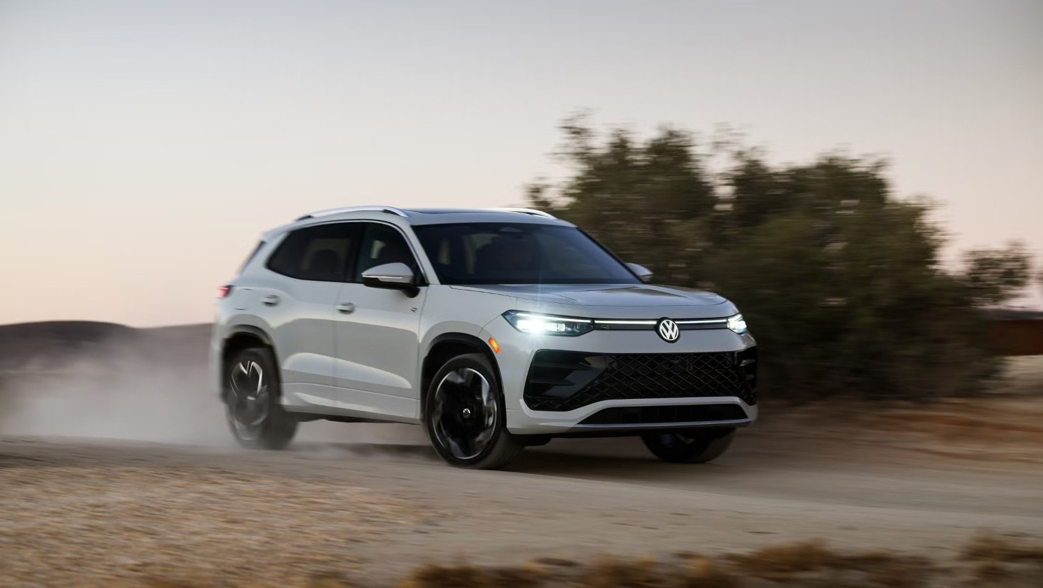 The 2026 Volkswagen Jetta GLI driving through a sharp turn, showcasing its precision handling.