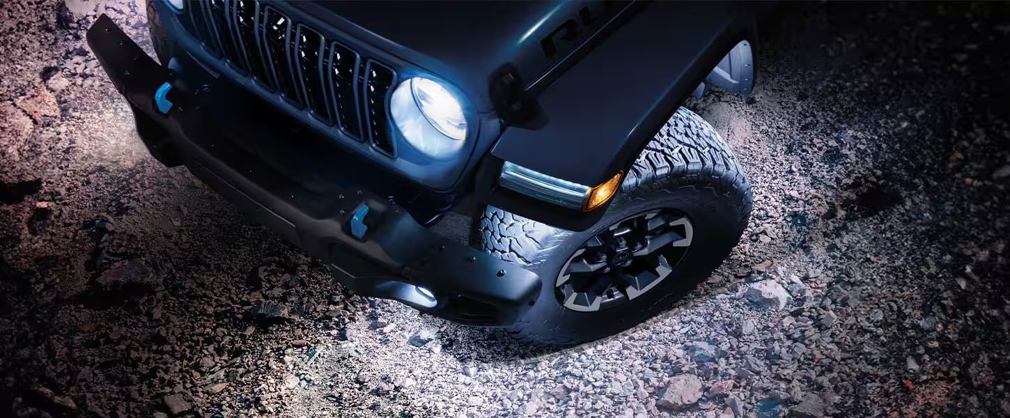 Close-up view of the updated seven-slot grille and LED headlights of the 2026 Jeep Wrangler.