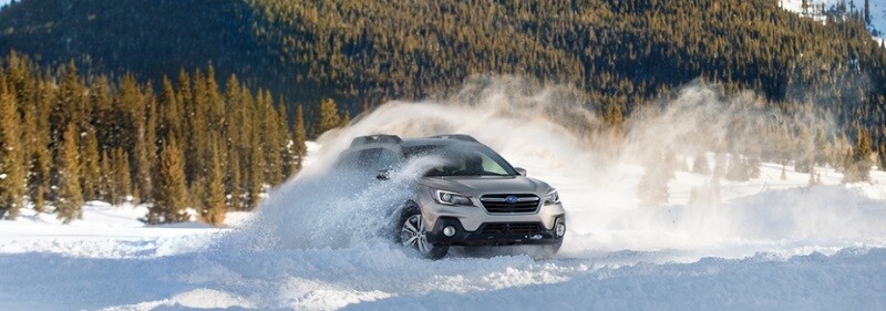 Subaru Outback driving through snow