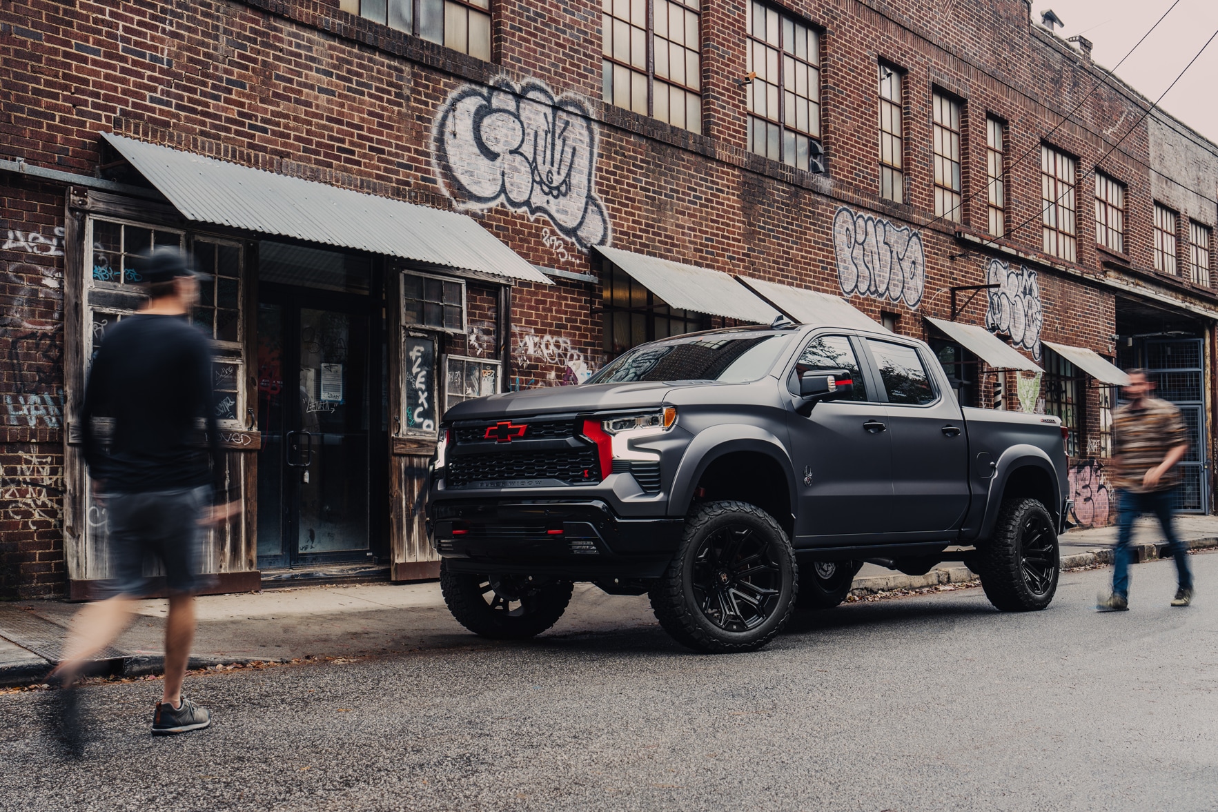 Matte black Black Widow Chevrolet Silverado 1500 in a city setting