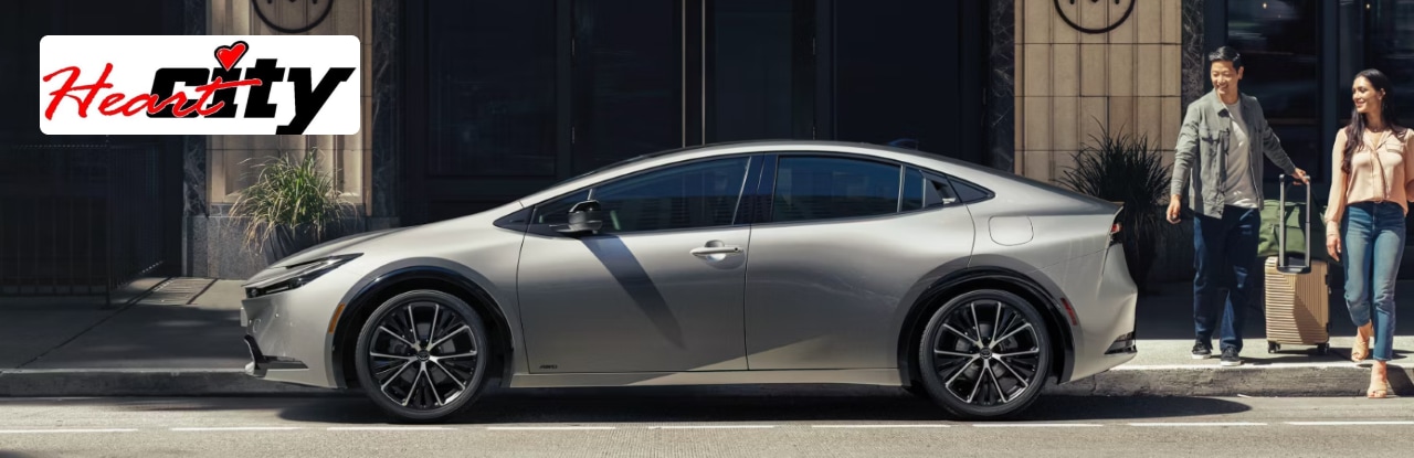 Heart City Toyota dealership in Elkhart, IN, with a new Toyota Prius.