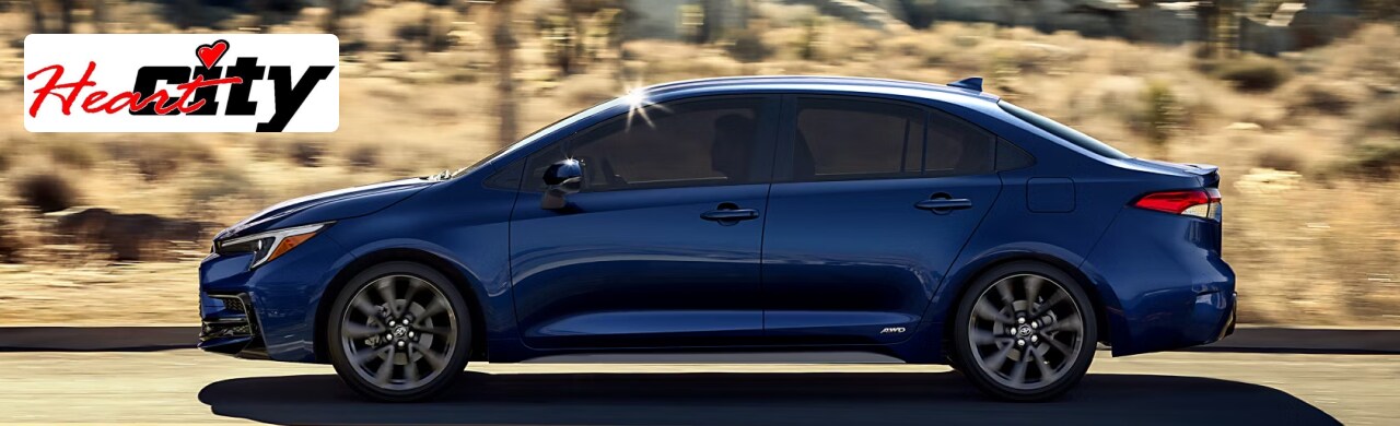 Toyota-Corolla-Compact-Efficient-and-Perfect-for-Your-Lifestyle1.png A blue Toyota Corolla driving on a road.