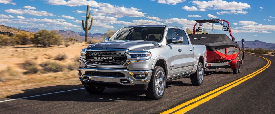 2019 Ram 1500 2019 Ram 1500 Towing a boat down an open desert road