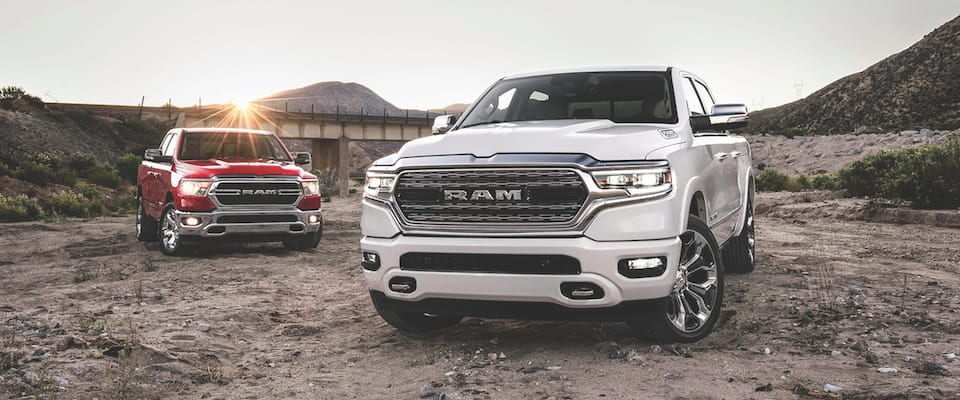 2019 Ram 1500 White and red 2019 Ram 1500s parked in the dirt