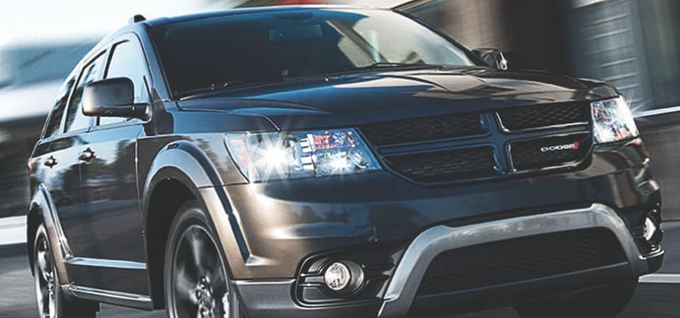 Dodge Journey A black Dodge Journey driving down a road