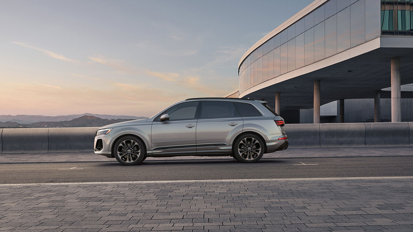 silver Audi Q7 parked near a modern building