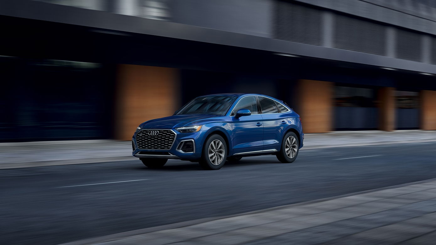 blue Audi Q5 driving in the city