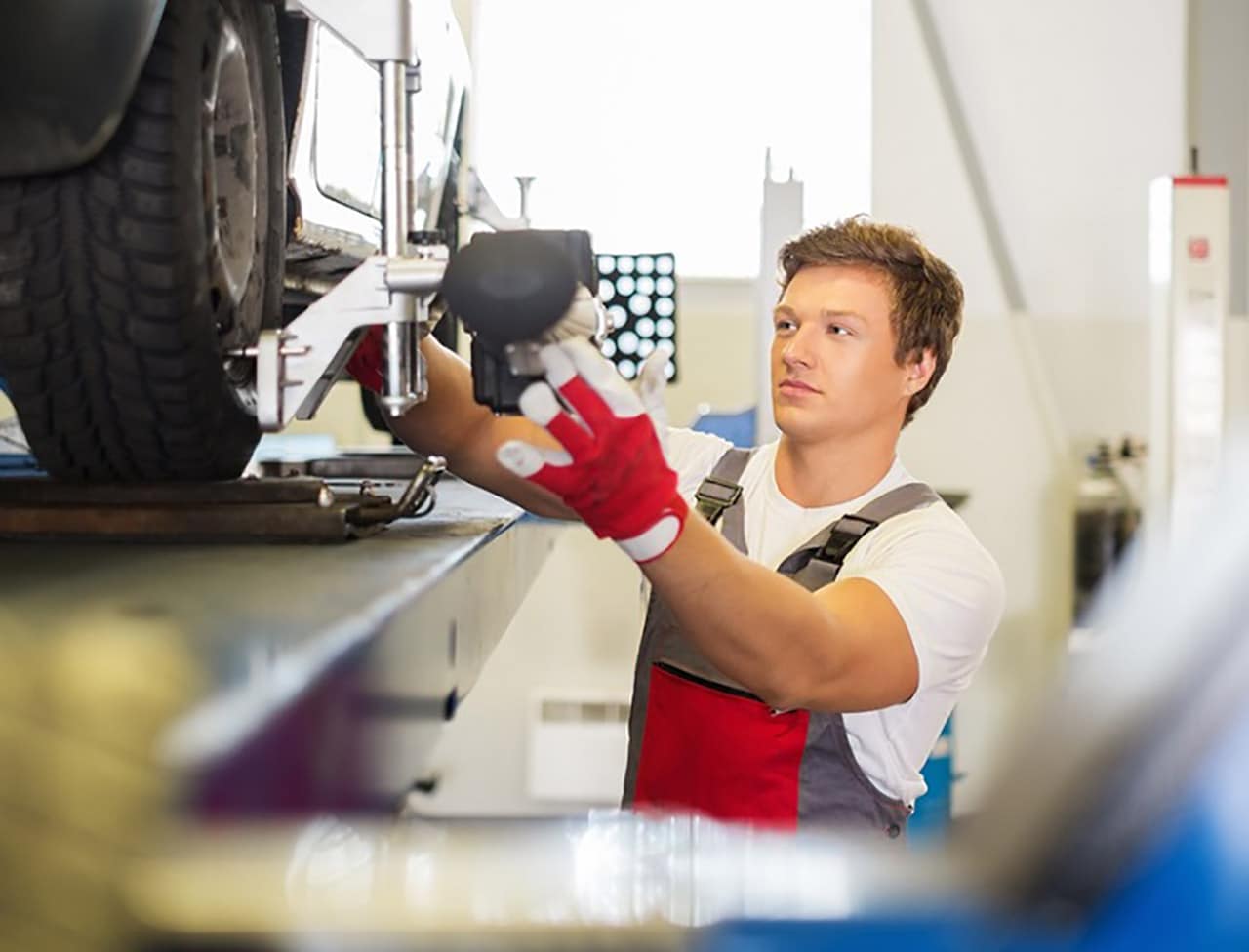 Man_Checking_Wheels_Alignment.jpg