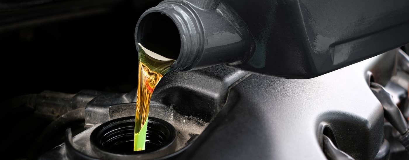 Oil being poured into an engine.