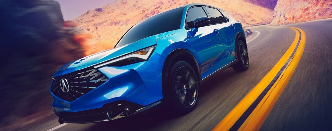 A blue 2026 Acura ADX driving on a highway.
