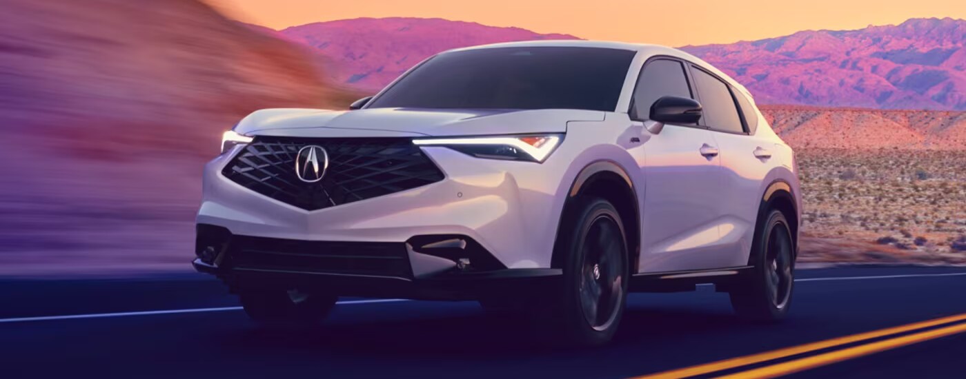 White 2025 Acura ADX driving down an open road