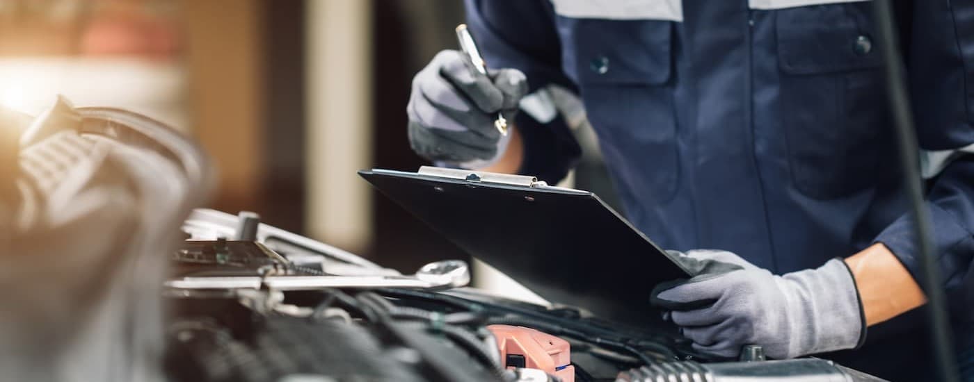 A mechanic holding a clipboard.
