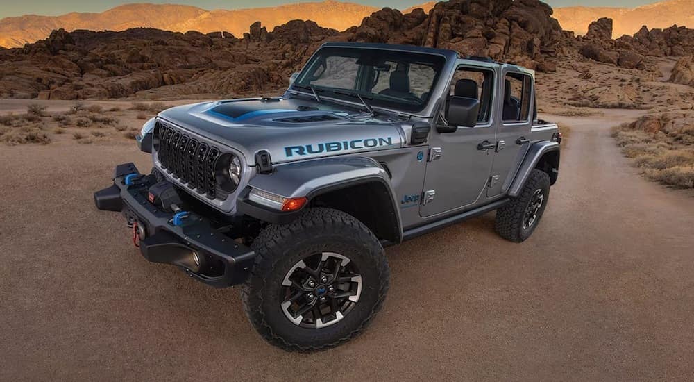 A grey 2024 Jeep Wrangler Rubicon 4xe is shown from the front at an angle.