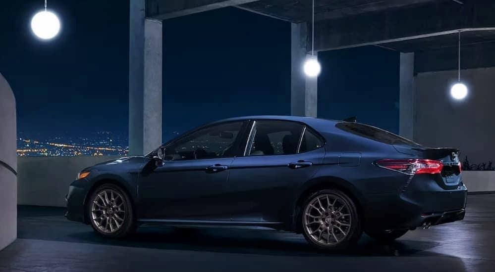 A blue 2022 Toyota Camry is shown parked in a parking garage.