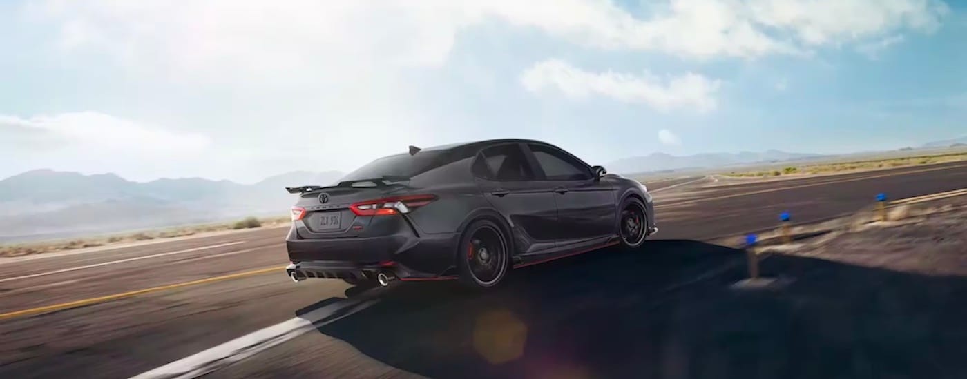 A black 2023 Toyota Camry TRD is shown from the rear at an angle after leaving a car dealership in Atlanta, GA.