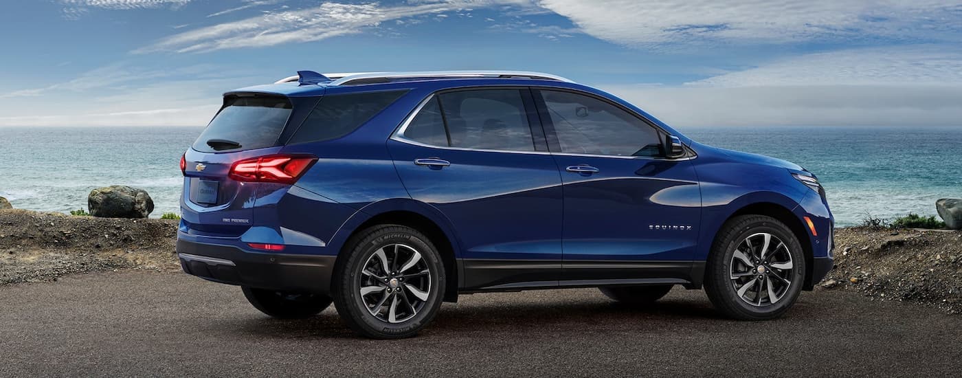 A blue 2022 Chevy Equinox Premier is shown from a rear angle.
