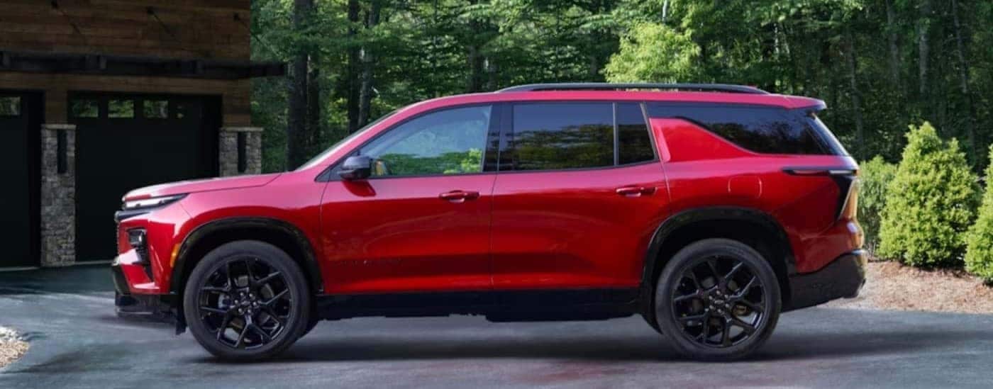 Side profile of a red 2024 Chevy Traverse