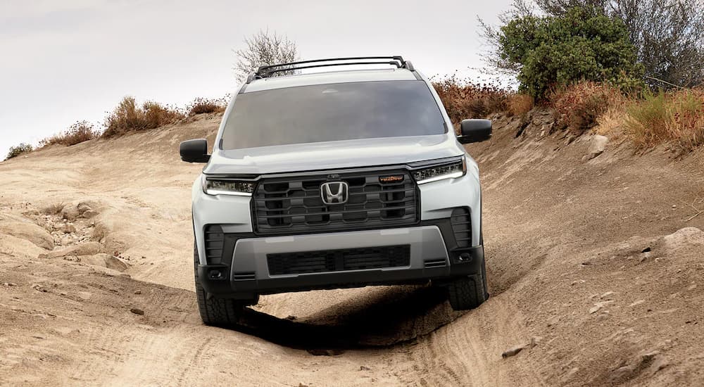 A silver 2026 Honda Pilot TrailSport off-roading