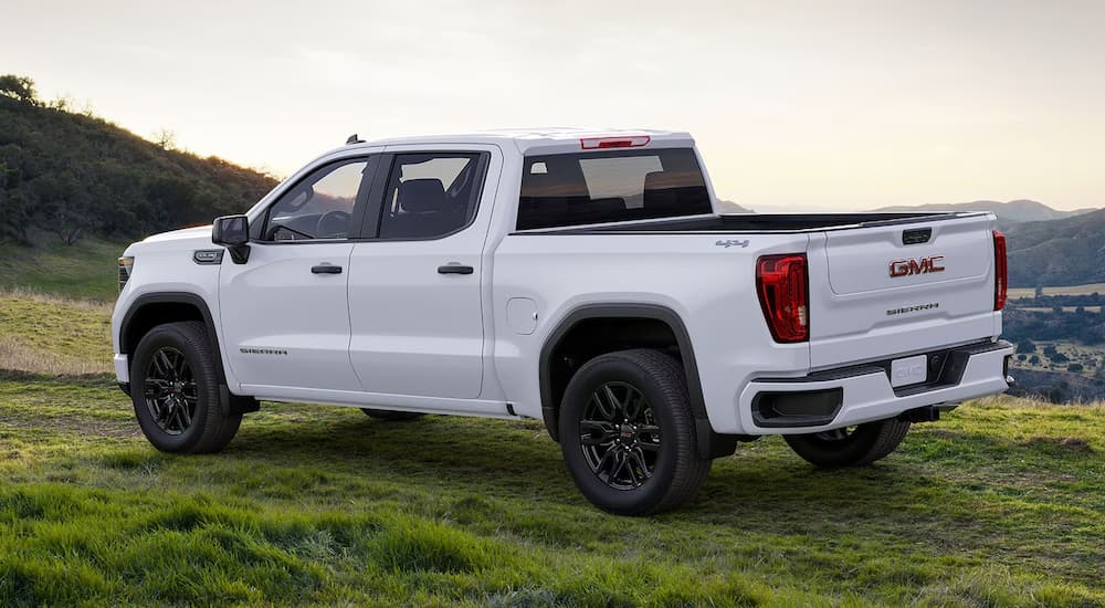 A white 2024 GMC Sierra 1500 is parked overlooking a mountain view.