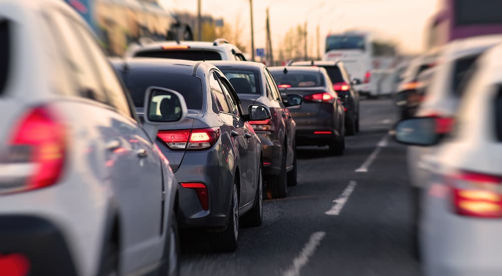 Many cars driving during peak city traffic hour.