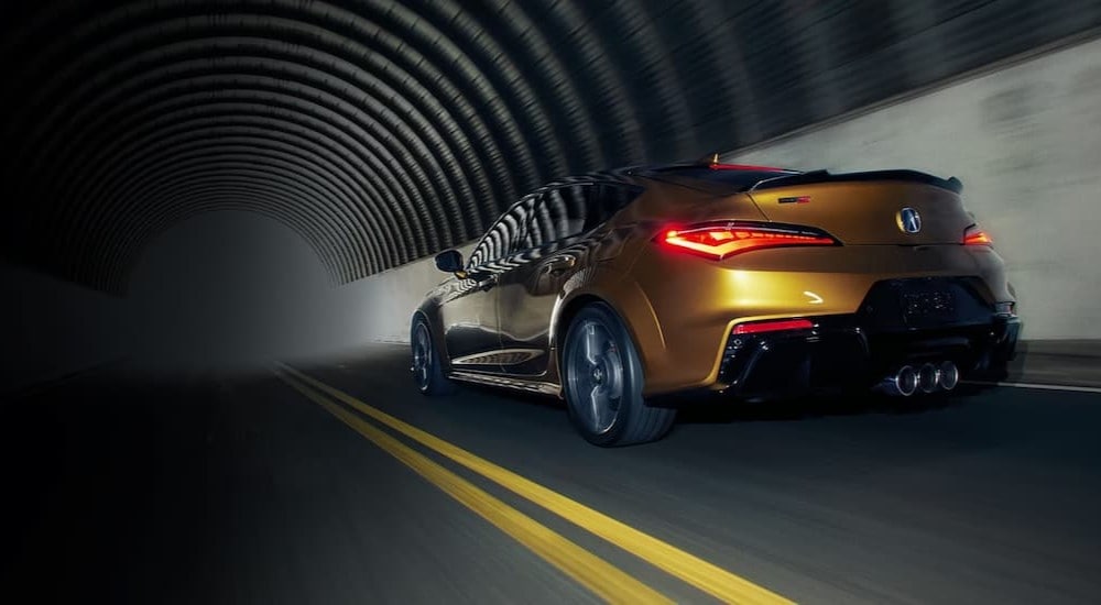 Car%20Dealership%20Near%20Cary%20-%202024%20Acura%20Integra%20Type%20S%20-%20Tunnel%202.jpg Rear of a yellow 2024 Acura Integra Type S driving through a tunnel.