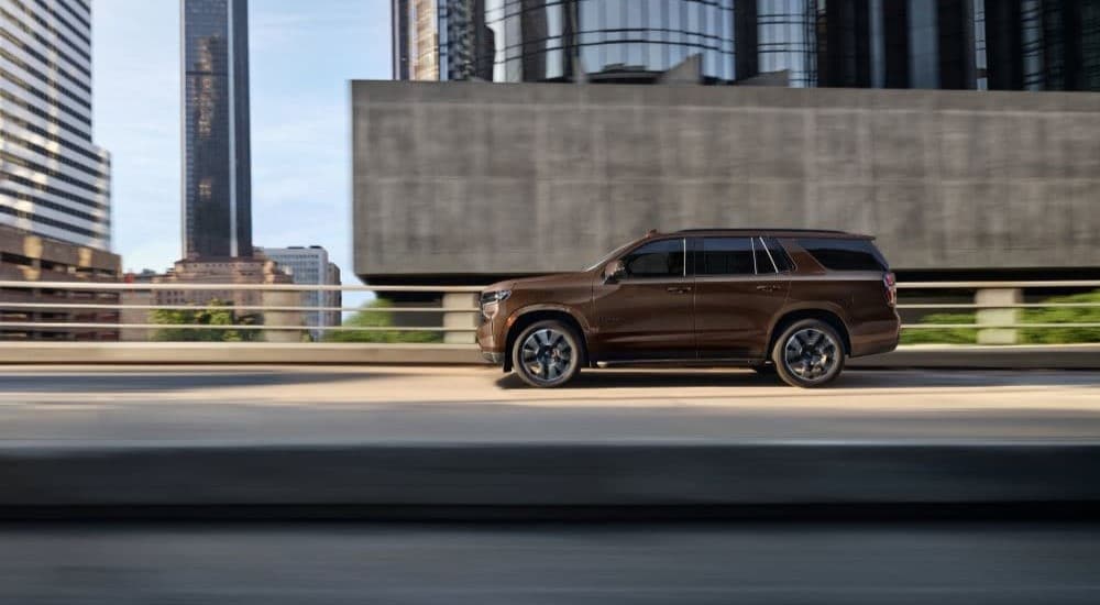 Brown 2022 Chevy Tahoe driving on a city street
