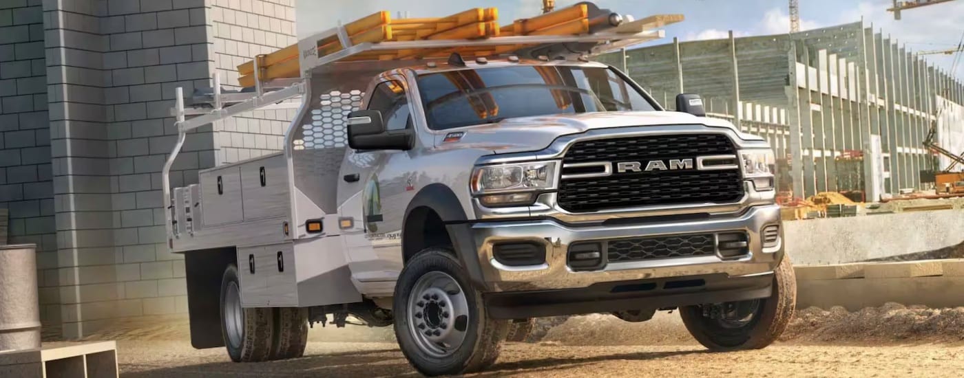 A white 2024 Ram 4500 SLT Chassis Cab at a construction site.