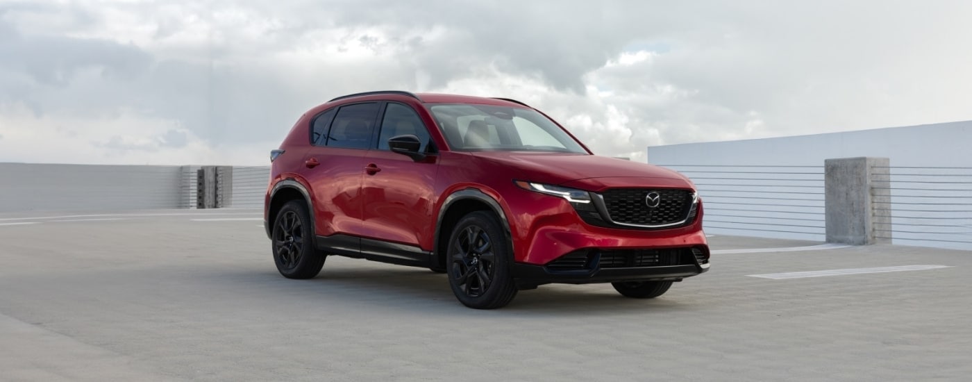 Red 2026 Mazda CX-5 parked on a cloudy day