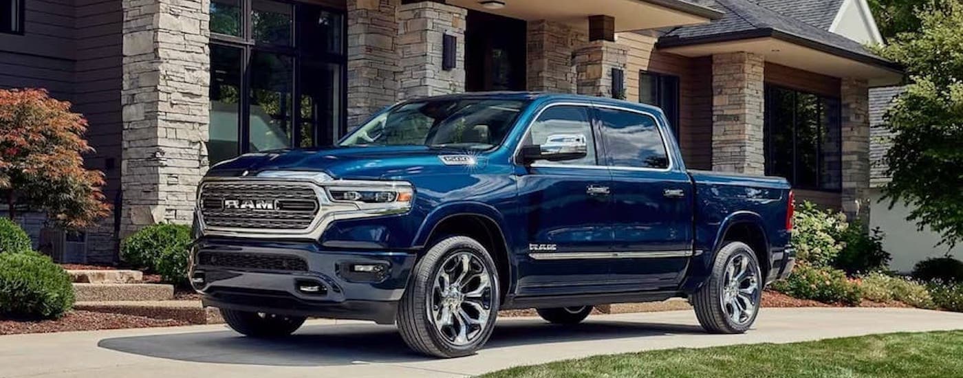 A blue 2025 Ram 1500 from the side after leaving a dealer that has trucks for sale near Chapel Hill.